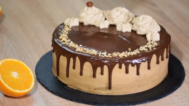 Female hand decorated the cake with chopped hazelnuts. - Footage, Video