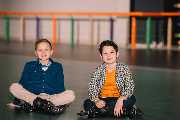 Little roller skaters looking at camera with smile - Photo, Image