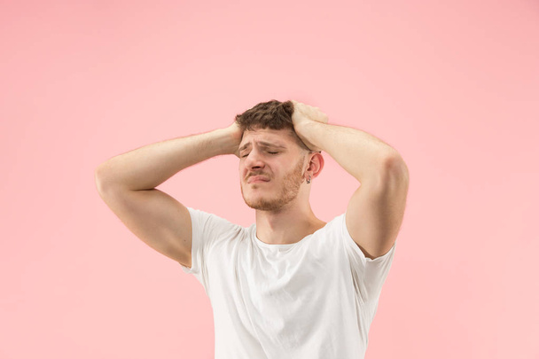 Man having headache. Isolated over pink background. - Фото, зображення