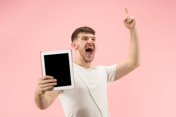 portrait of smiling man pointing at laptop with blank screen isolated on white - Photo, image
