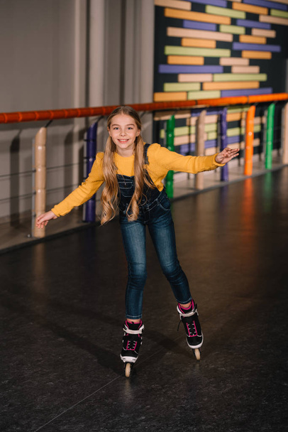Female roller skater in jeans enjoying childhood - Photo, image