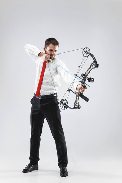 Businessman aiming at target with bow and arrow, isolated on white background - Valokuva, kuva