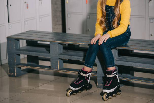 Cropped view of child with long hair posing in roller skates - Foto, immagini