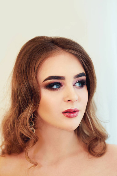 Beautiful model girl with Fashion Luxury Makeup, long eyelashes, perfect skin facial make-up. Beauty Brunette model woman holiday make up close up. Eyelash extensions, false eyelashes. Beauty Woman. - 写真・画像