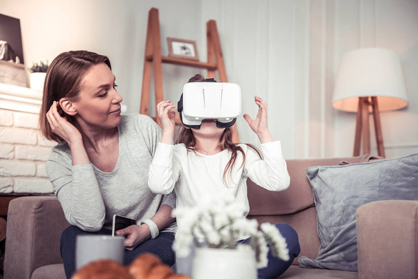 Pleasant excited girl being in the virtual reality - Fotoğraf, Görsel