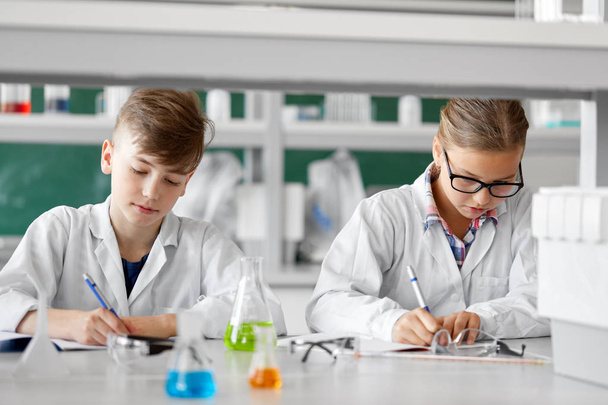 kids studying chemistry at school laboratory - Photo, image
