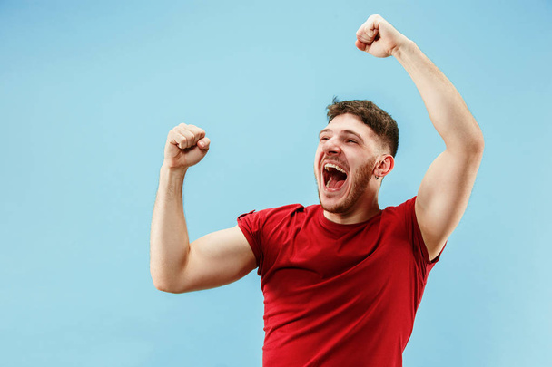 Winning success man happy ecstatic celebrating being a winner. Dynamic energetic image of male model - Photo, Image