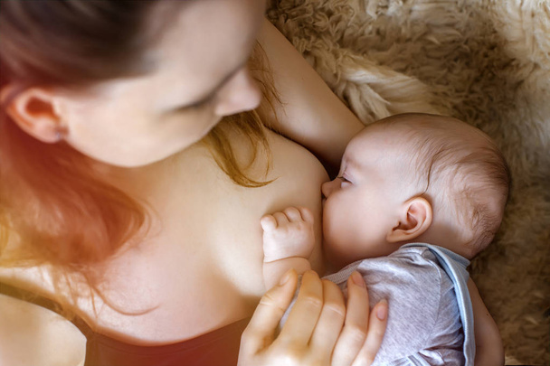 a young mother feeds the baby. breast feeding. health. food. immunity. - Photo, Image