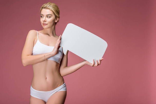 beautiful blonde woman in white underwear posing with empty speech bubble, isolated on pink - Fotoğraf, Görsel