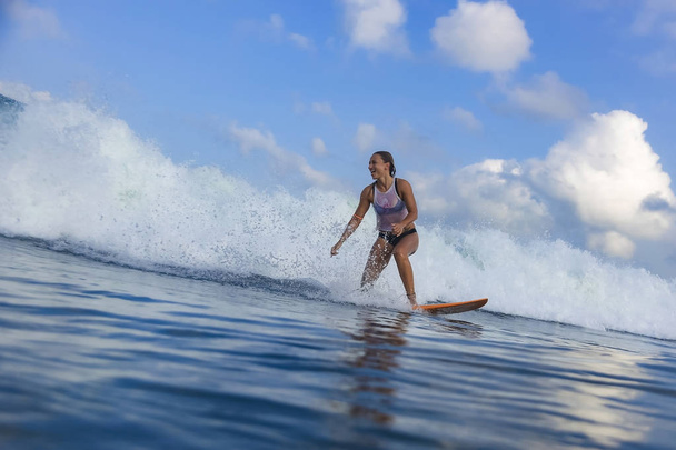 Young woman on blue wave - Fotografie, Obrázek