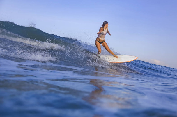 Young woman on blue wave - Foto, imagen