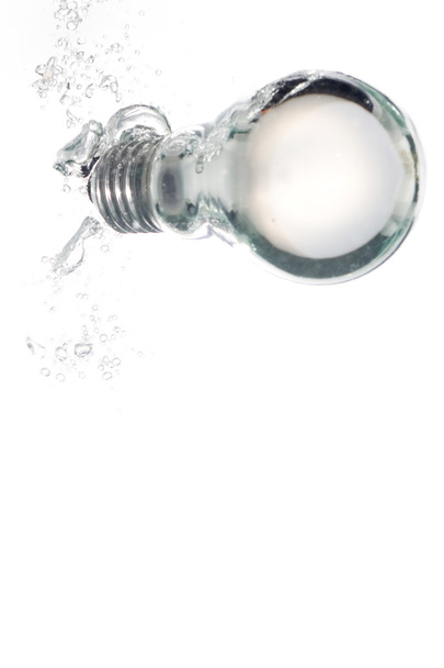 A light bulb falling into clear water - Photo, Image