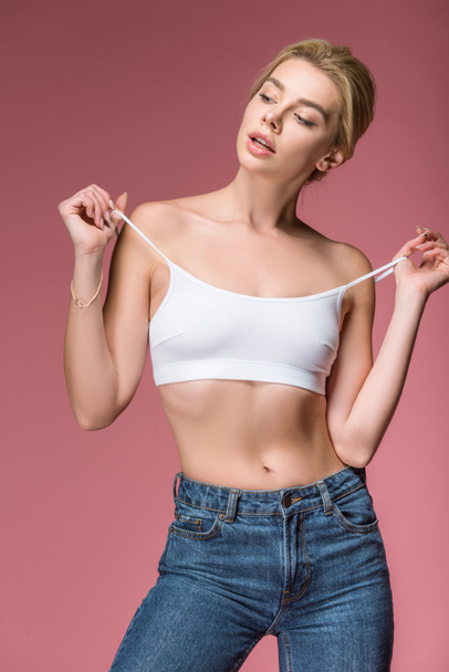 beautiful woman posing in white bra, isolated on pink - Фото, изображение