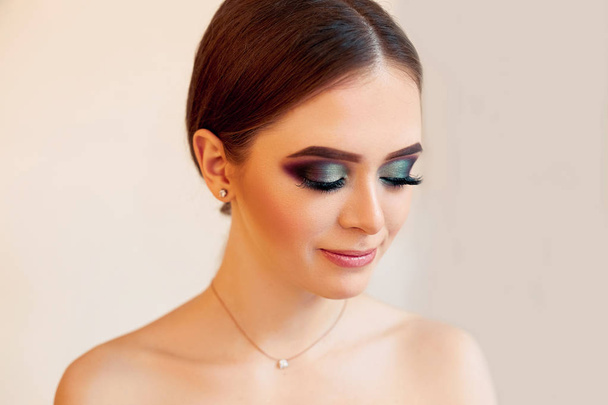 Beautiful model girl with Fashion Luxury Makeup, long eyelashes, perfect skin facial make-up. Beauty Brunette model woman holiday make up close up. Eyelash extensions, false eyelashes. Beauty Woman face Portrait. - 写真・画像