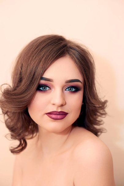 Beautiful model girl with curly hair, Fashion Luxury Makeup. Pretty Young Female with Clean Fresh Skin close up. Skin care face. Cosmetology. Beauty Woman face Portrait. - Fotó, kép