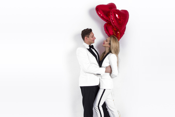 Happy beautiful couple posing on white background and holding balloons heart. Valentine's day. - Image - Foto, Imagem