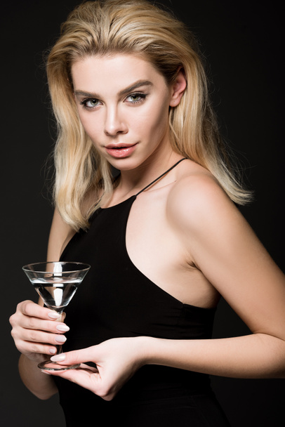 beautiful woman girl in black dress posing with cocktail glass isolated on black - Photo, Image