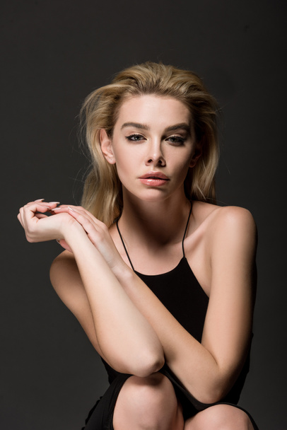 attractive sexy blonde girl in black dress posing isolated on black - Fotografie, Obrázek