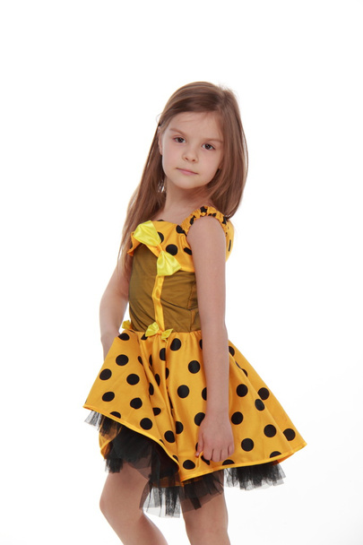 Charming emotional little girl in a yellow dress - Photo, Image