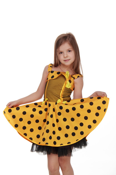 Charming emotional little girl in a yellow dress - Zdjęcie, obraz
