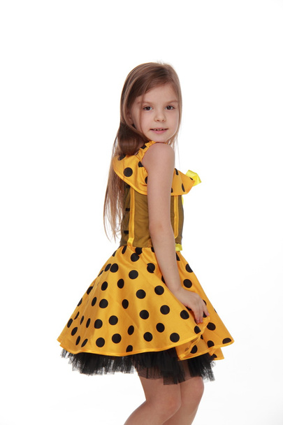 Charming emotional little girl in a yellow dress - Fotografie, Obrázek
