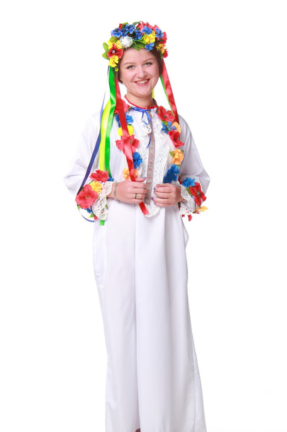 Girl in flowers wreath and traditional ukrainian clothes on white background - Фото, зображення
