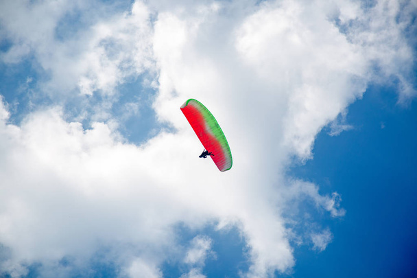 Skydiver On Colorful Parachute In Blue Sky. Active Hobbies - Photo, Image