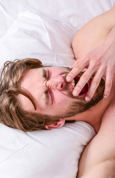 Man handsome guy lay in bed. Get adequate and consistent amount of sleep every night. How much sleep you actually need. Bearded man sleeping face relaxing on pillow. Expert tips on sleeping better - Foto, afbeelding