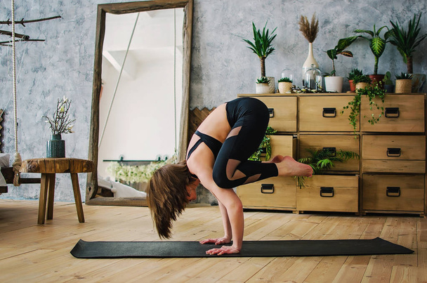 Sports girl doing yoga at home - Photo, Image