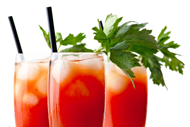 Close up of bloody mary with ice cubes and tomatoes isolated on white background - Photo, image