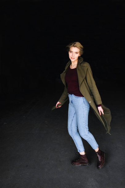 Beautiful young blonde woman in stylish coat on dark background - Foto, afbeelding