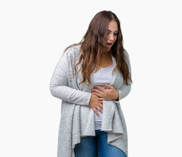 Beautiful plus size young woman wearing winter jacket over isolated background with hand on stomach because nausea, painful disease feeling unwell. Ache concept. - Foto, Imagen