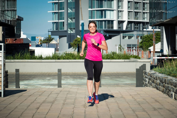 женщина в спортивной одежде бежит по каналу в общественном парке в Кейптауне, Южная Африка
 - Фото, изображение