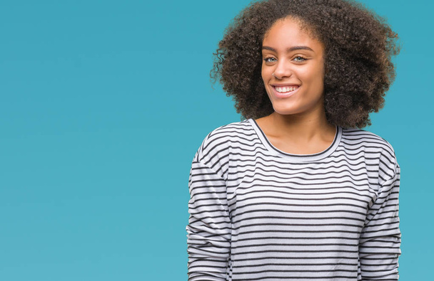 Young afro american woman over isolated background looking away to side with smile on face, natural expression. Laughing confident. - Photo, Image
