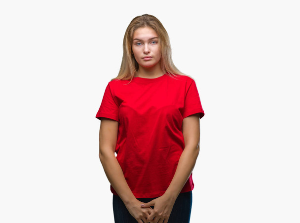 Young caucasian woman over isolated background with serious expression on face. Simple and natural looking at the camera. - Foto, Bild