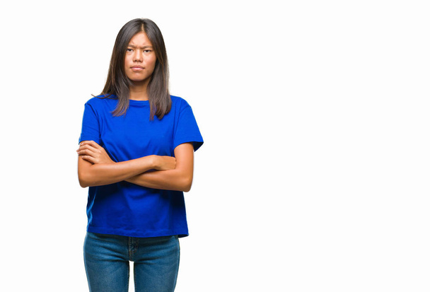 Young asian woman over isolated background skeptic and nervous, disapproving expression on face with crossed arms. Negative person. - Foto, Imagen