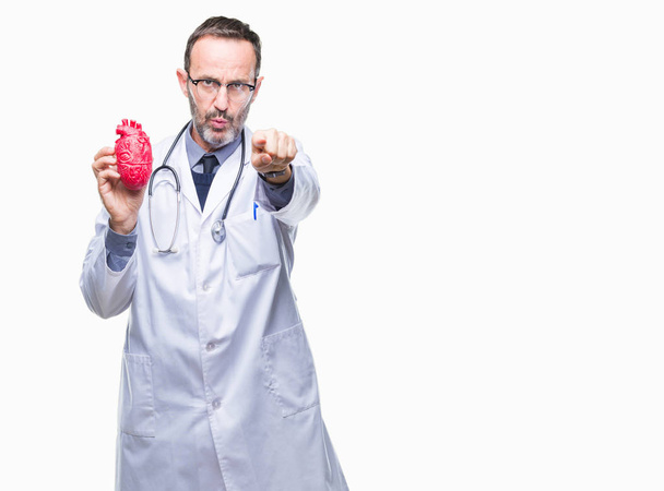 Middle age senior hoary cardiologist doctor man holding heart over isolated background pointing with finger to the camera and to you, hand sign, positive and confident gesture from the front - Foto, afbeelding