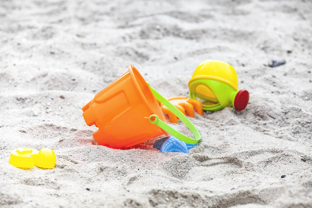 Set of color plastic toys on a sand - Fotó, kép