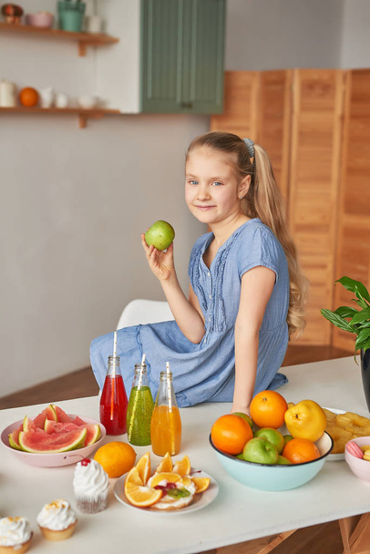 The girl eats fruit pineapple, watermelon, apples and drinks drinks from chia. Healthy food in the children's menu - Фото, зображення