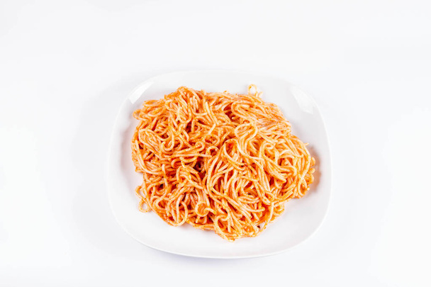 Spaghetti with pesto on a plate on a white background - Photo, Image