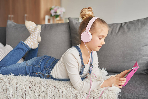 girl in headphones listening to music at home - 写真・画像