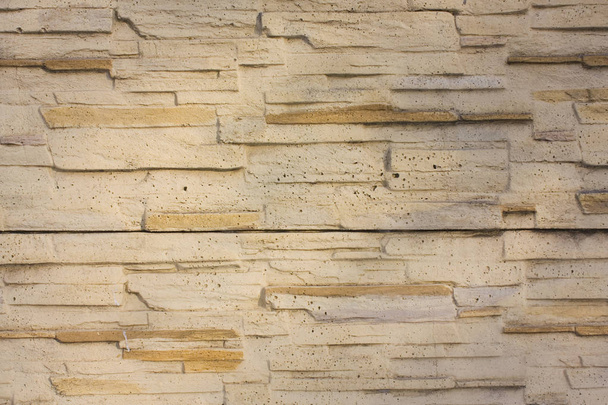 Muro de piedra, fondo de ladrillos beige
 - Foto, imagen