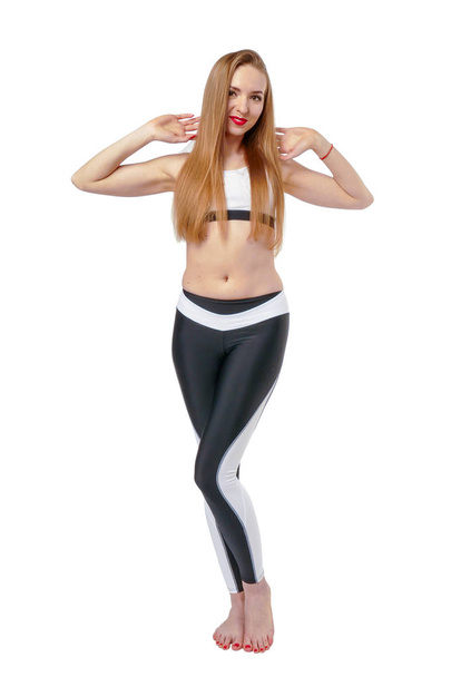 Young attractive woman posing in fitnes wear - Фото, изображение
