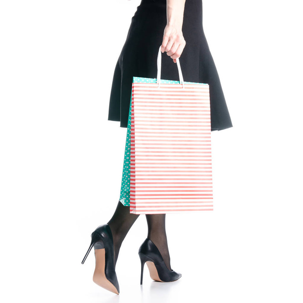 Female legs in black high heels shoes bags package black skirt fashion - Fotó, kép