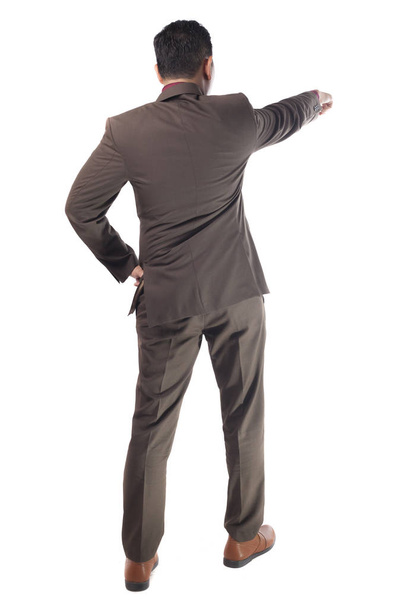 Young businessman wearing brown suit looking forward gesture, rear view. Isolated on white. Full body portrait - Foto, imagen