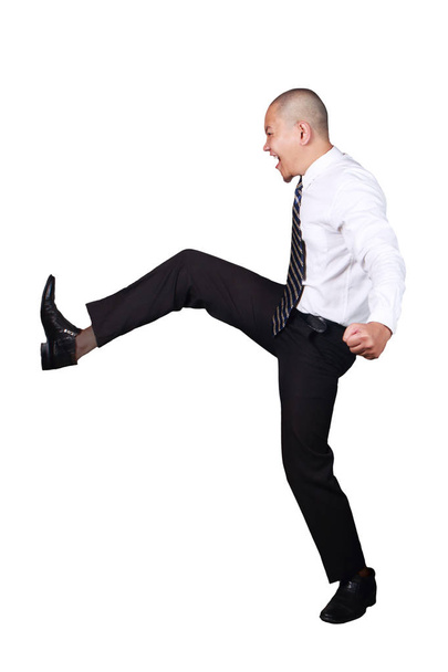 Young businessman wearing white suit and black pants kicking gesture, screams expression. Isolated on white. Full body portrait - Foto, immagini