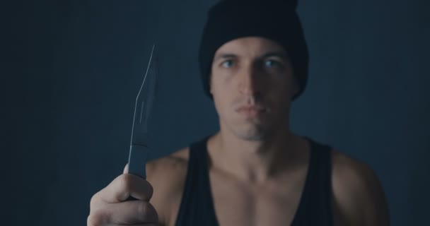 Πορτρέτο του επικίνδυνος άνθρωπος σε ένα καπέλο με ένα μαχαίρι - Πλάνα, βίντεο