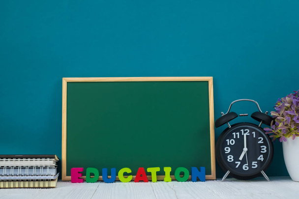 Back to school concept idea, Education text and green chalkboard with pile of notebook paper, stationery or school supplies. - Foto, immagini