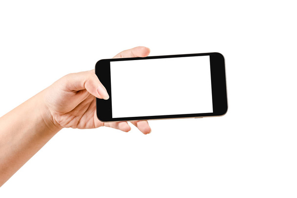 Bliska ręka trzyma czarny telefon na białym tle. Może używać do pokazywania multimediów lub produktów. - Zdjęcie, obraz