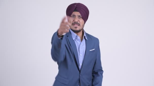 Angry bearded Indian Sikh businessman talking and pointing at camera - Materiaali, video